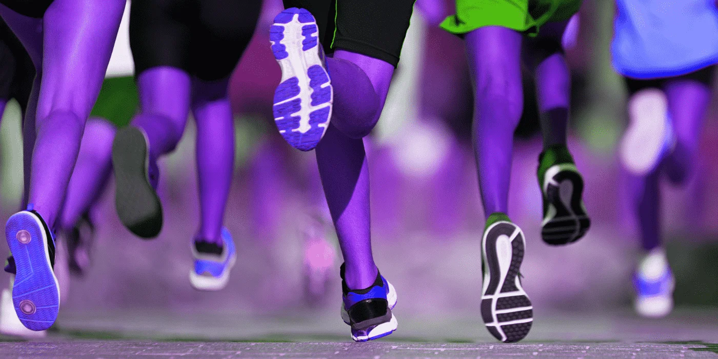 Runners' colorful athletic shoes mid-stride during a race viewed from behind